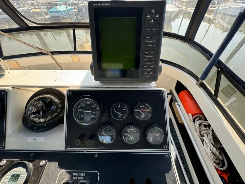Slide: The Image of Control panel of a 1991 Carver 33 Aft Cabin with navigation equipment and gauges. - 13