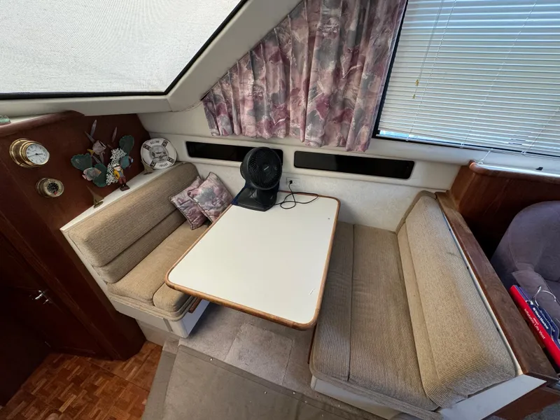 Slide: The Image of Interior of 1991 Carver 33 Aft Cabin with dining area and seating. - 24