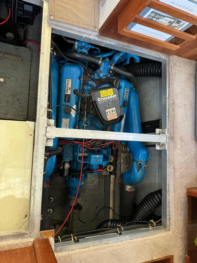 Slide: The Image of Engine compartment of a 1991 Carver 33 Aft Cabin boat, featuring a Crusader engine. - 37