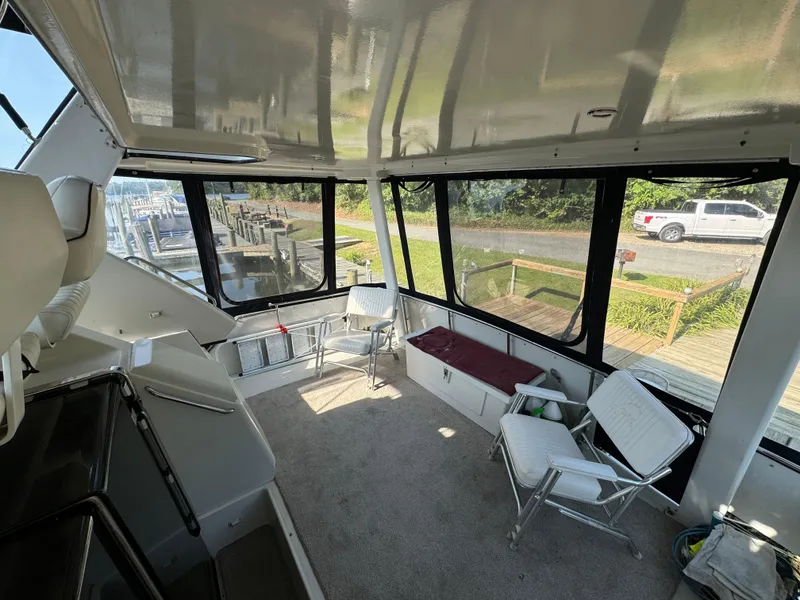 Slide: The Image of Interior of 1991 Carver 33 Aft Cabin with seating and large windows. - 9