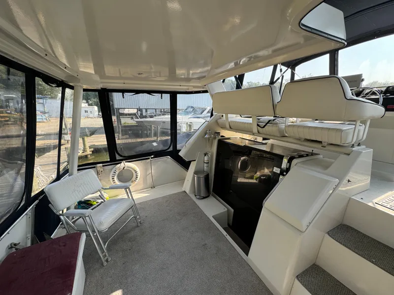 Slide: The Image of 1991 Carver 33 Aft Cabin interior with seating, carpet, and windows. - 10