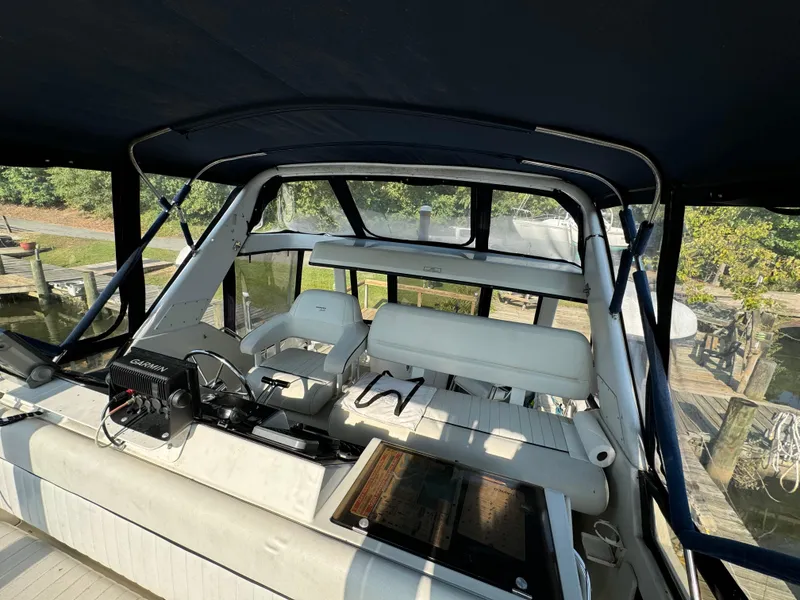 Slide: The Image of 1991 Carver 33 Aft Cabin boat interior with seating and control panel. - 20