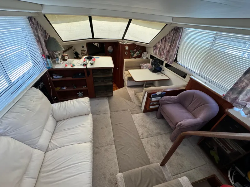 Slide: The Image of Interior of 1991 Carver 33 Aft Cabin yacht with cozy seating and dining area. - 21