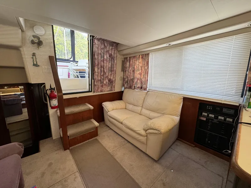 Slide: The Image of Interior of 1991 Carver 33 Aft Cabin with sofa, stairs, and window blinds. - 23