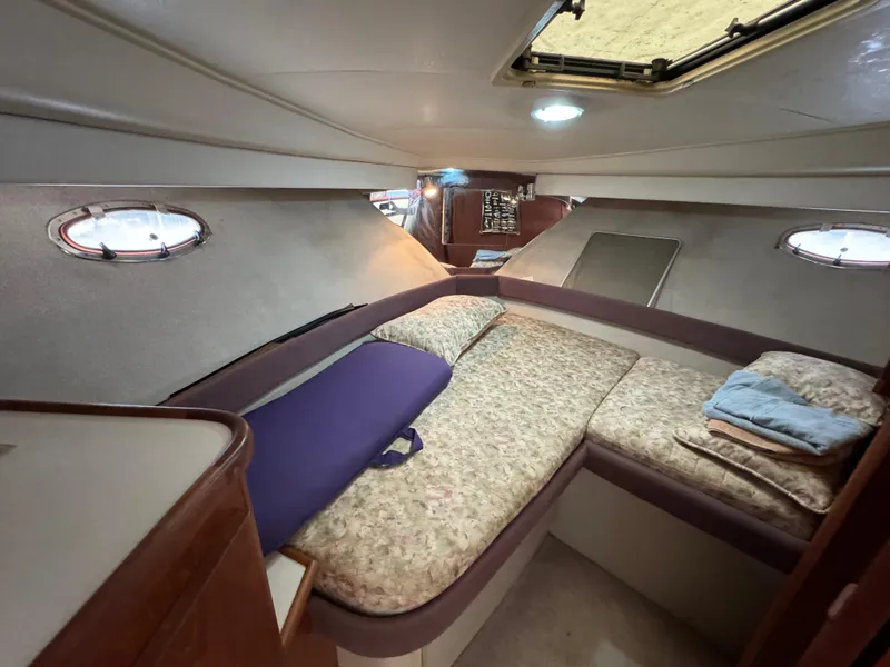 Slide: The Image of 1991 Carver 33 Aft Cabin interior with cozy sleeping area and porthole windows. - 28