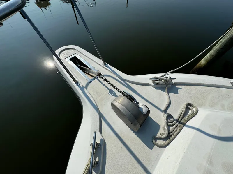 Slide: The Image of Bow of 1991 Carver 33 Aft Cabin with anchor and ropes on calm water. - 6