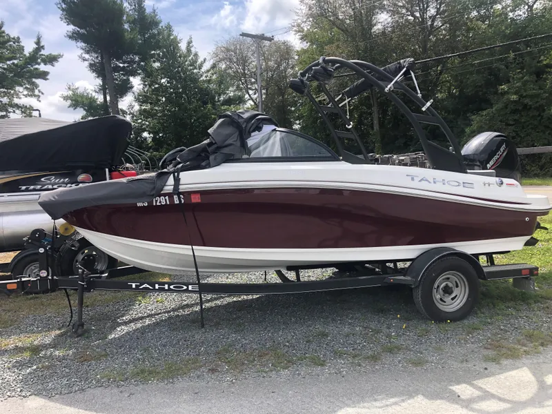Slide: The Image of 2022 Tahoe 185 S boat on trailer, parked outdoors. - 7