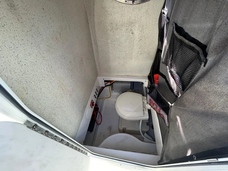 Slide: The Image of Interior of 2015 Wellcraft 252 Fisherman boat with compact marine toilet. - 12