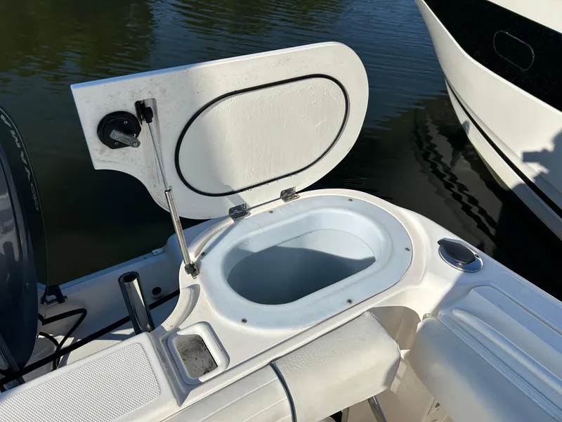 Slide: The Image of 2015 Wellcraft 252 Fisherman boat with open storage compartment on deck. - 13