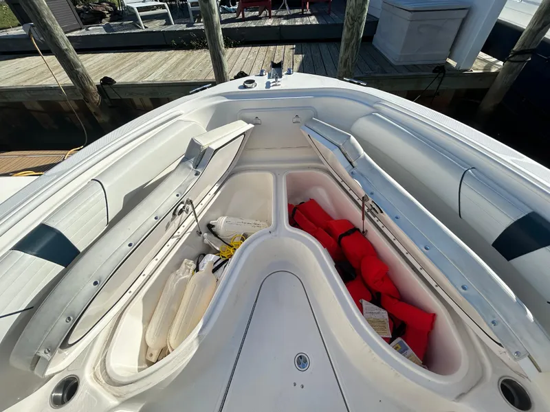 Slide: The Image of 2015 Wellcraft 252 Fisherman boat storage compartments with life jackets and gear. - 6