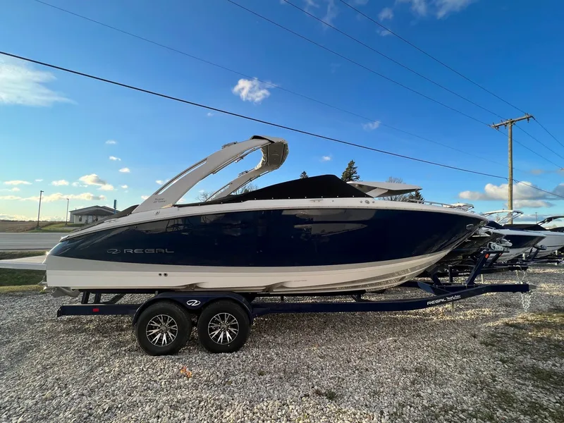 The Image of 2025 Regal LS9 boat on trailer under clear blue sky. - 0