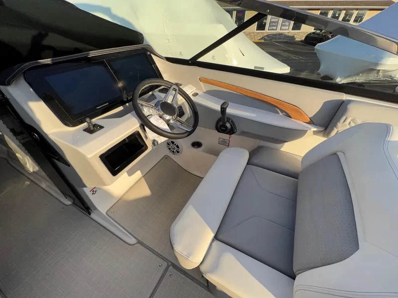 Slide: The Image of 2025 Regal LS9 boat cockpit with modern steering and seating. - 12