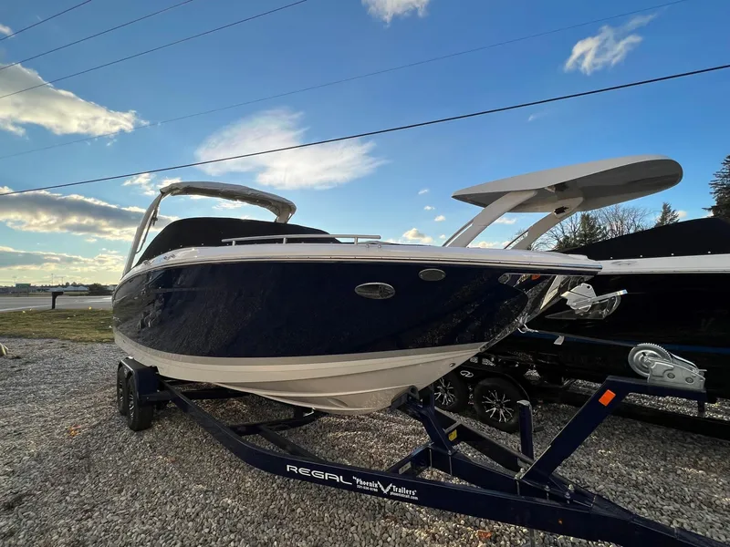 Slide: The Image of 2025 Regal LS9 boat on trailer under blue sky. - 2