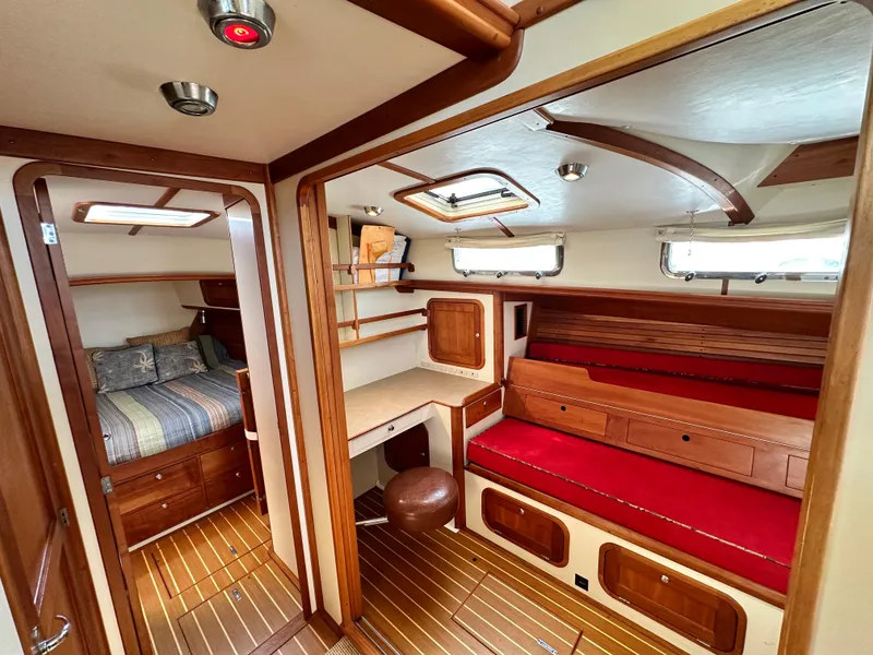 Slide: The Image of Luxurious interior of 2005 Legacy 42 yacht with wood accents and red seating. - 11