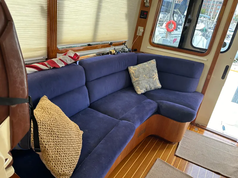 Slide: The Image of Interior of 2005 Legacy 42 boat with blue sofa and decorative pillows. - 12