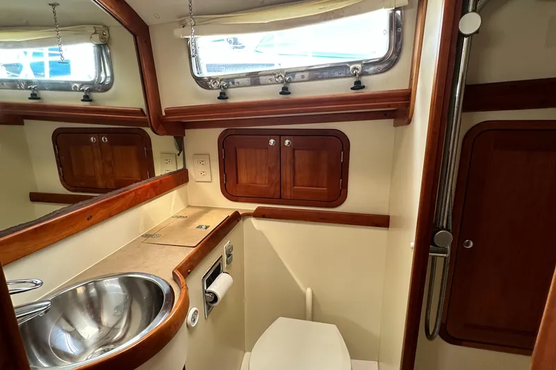 Slide: The Image of Luxurious 2005 Legacy 42 yacht bathroom with wood accents and stainless steel sink. - 20