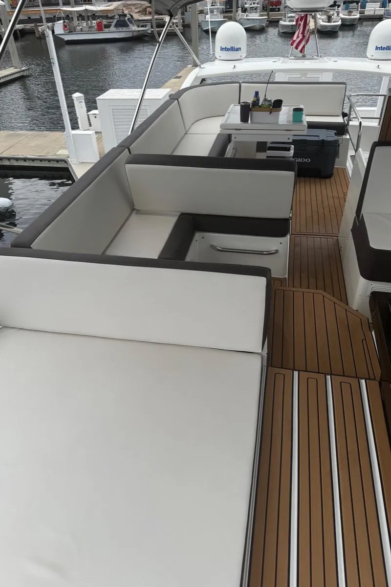 Slide: The Image of 2019 Galeon 500 Fly yacht with spacious deck and seating area at marina. - 10