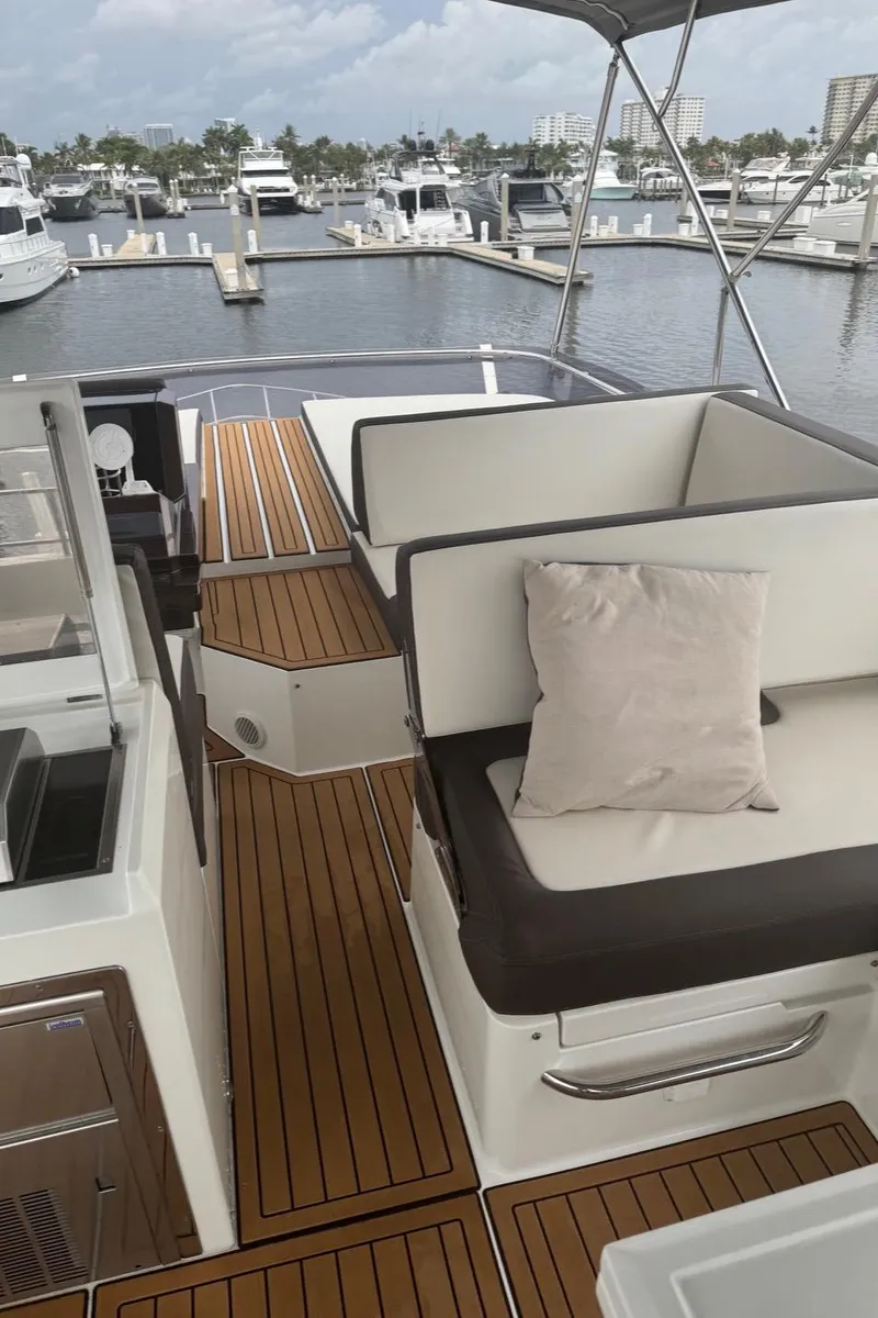 Slide: The Image of Galeon 500 Fly 2019 yacht interior with elegant seating and marina view. - 14