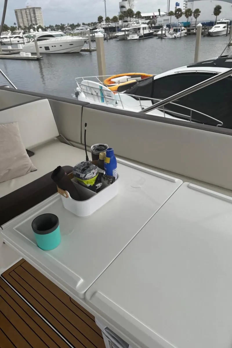 Slide: The Image of 2019 Galeon 500 Fly yacht deck with marina view and seating area. - 16