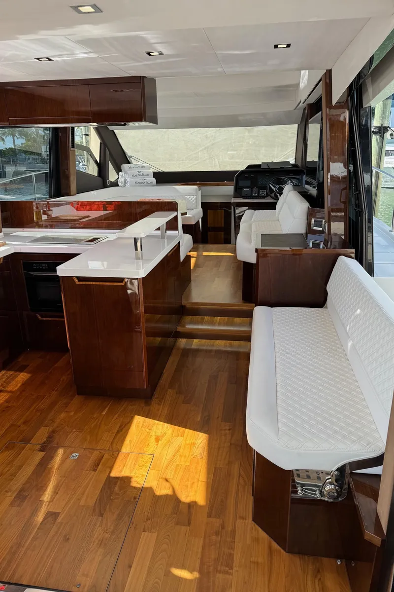 Slide: The Image of Interior of 2019 Galeon 500 Fly yacht with modern seating and wooden flooring. - 19