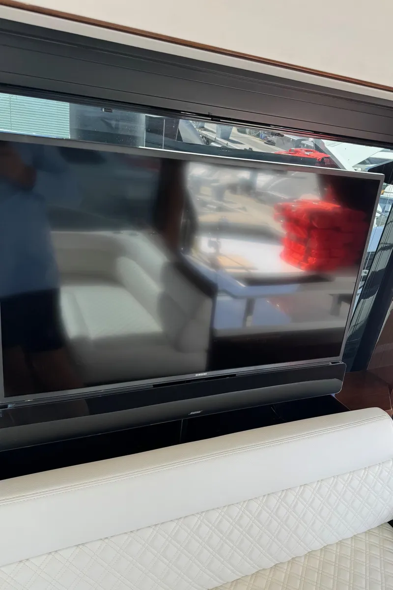 Slide: The Image of Interior of 2019 Galeon 500 Fly yacht with modern TV and seating area. - 20