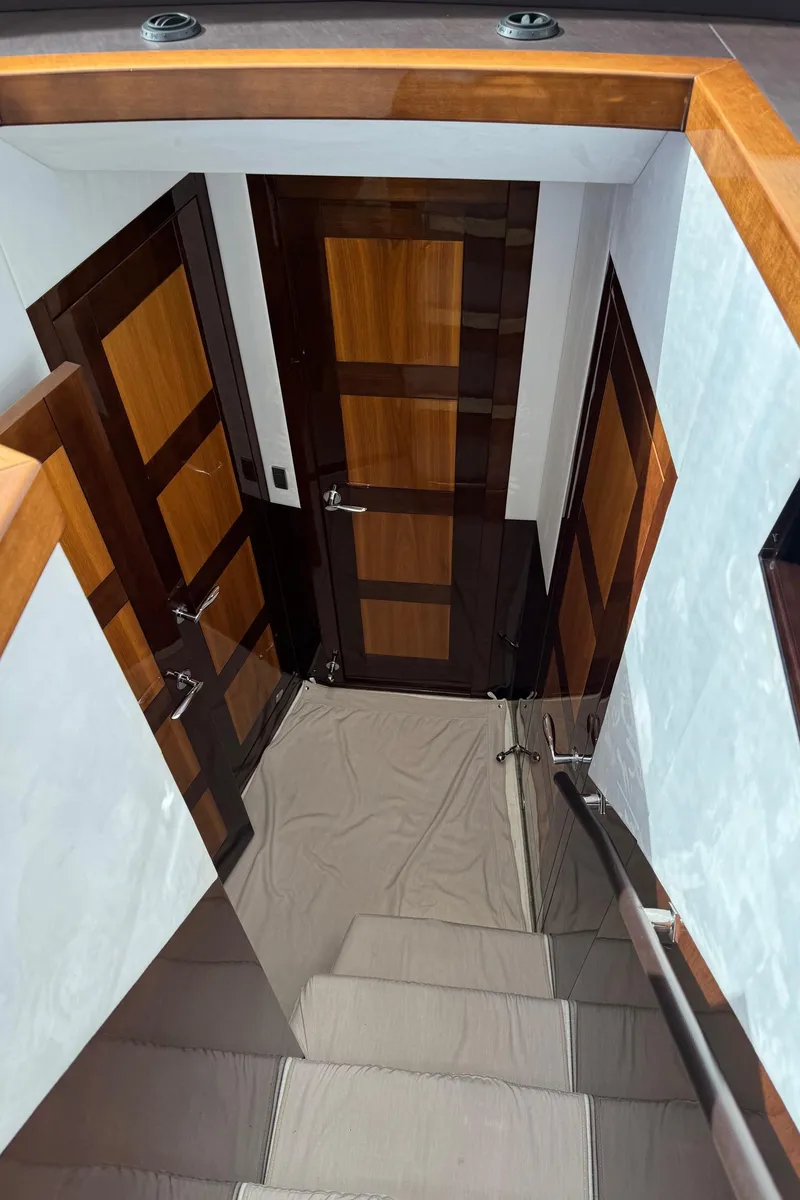 Slide: The Image of Interior staircase of 2019 Galeon 500 Fly yacht with wooden doors. - 23