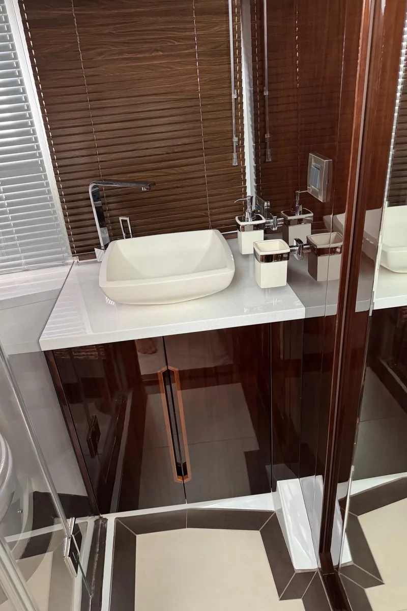Slide: The Image of Luxurious bathroom interior on 2019 Galeon 500 Fly yacht with modern sink and wood accents. - 29