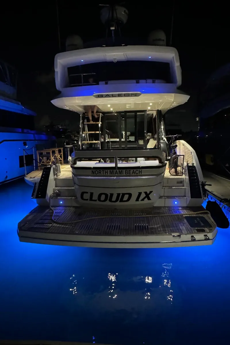 Slide: The Image of 2019 Galeon 500 Fly yacht with blue underwater lights at night. - 6