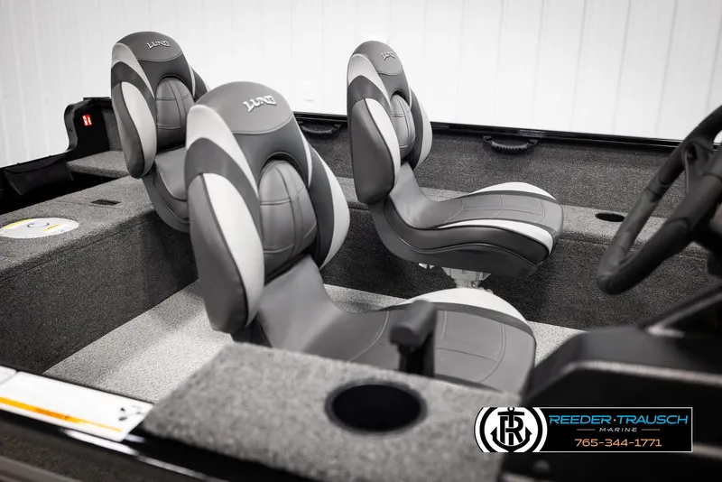 Slide: The Image of 2025 Lund 1650 Rebel XL SS boat interior with gray seating and steering wheel. - 11
