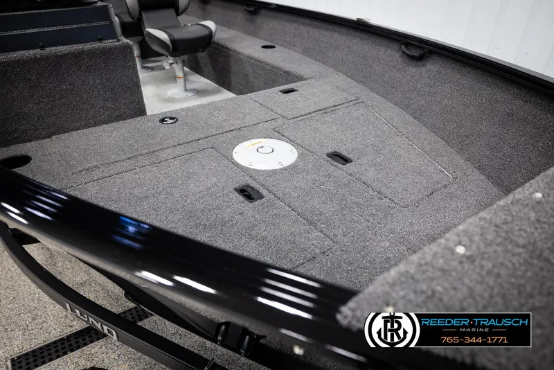 Slide: The Image of 2025 Lund 1650 Rebel XL SS boat interior with carpeted deck and seating. - 13
