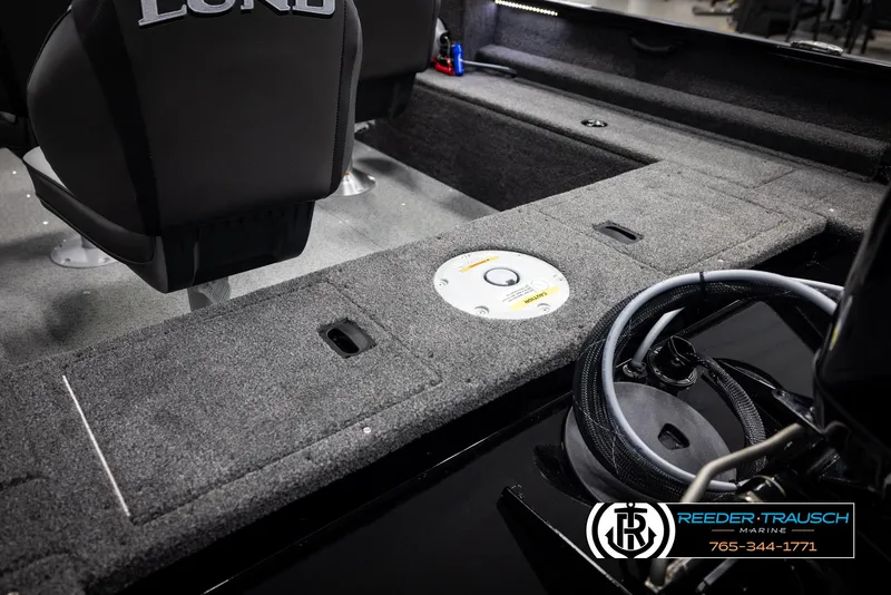 Slide: The Image of 2025 Lund 1650 Rebel XL SS boat interior with seating and storage compartments. - 15