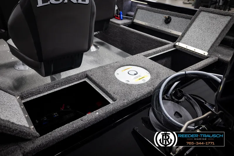 Slide: The Image of 2025 Lund 1650 Rebel XL SS boat interior with storage compartments and seating. - 16