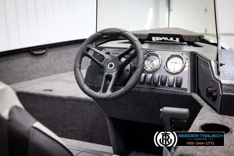 Slide: The Image of 2025 Lund 1650 Rebel XL SS boat interior with steering wheel and dashboard controls. - 17