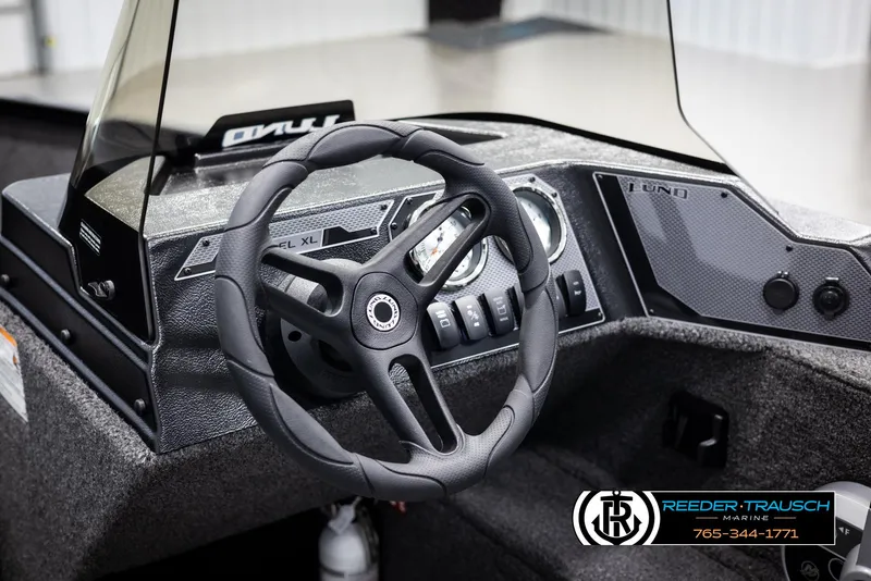 Slide: The Image of 2025 Lund 1650 Rebel XL SS boat dashboard with steering wheel and control panel. - 18