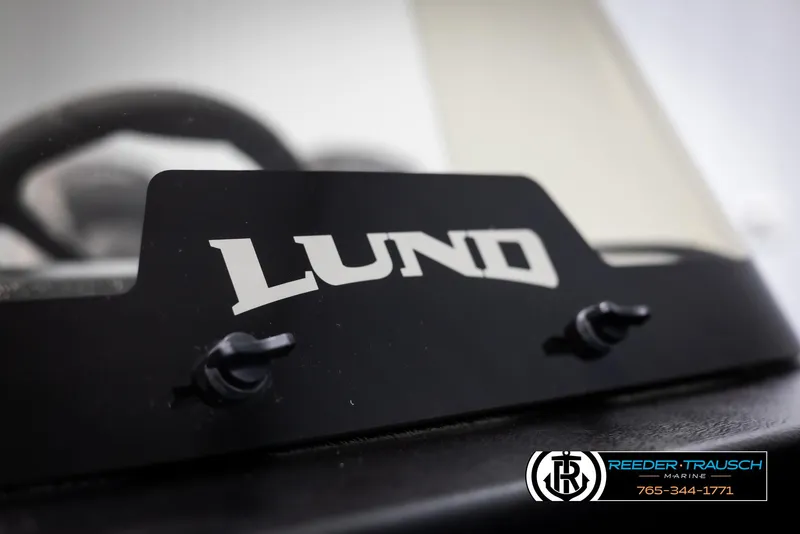 Slide: The Image of 2025 Lund 1650 Rebel XL SS boat dashboard with logo and contact details. - 34