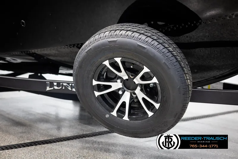 Slide: The Image of 2025 Lund 1650 Rebel XL SS trailer wheel, black and silver design. - 36