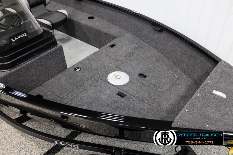 Slide: The Image of 2025 Lund 1650 Rebel XL SS boat interior with gray carpet and seating. - 7
