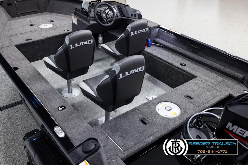 Slide: The Image of 2025 Lund 1650 Rebel XL SS boat interior with three seats and steering console. - 9
