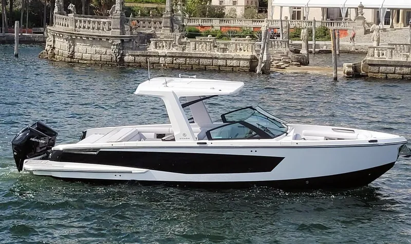 The Image of 2023 Aviara AV32 motorboat on calm water with historic backdrop. - 0
