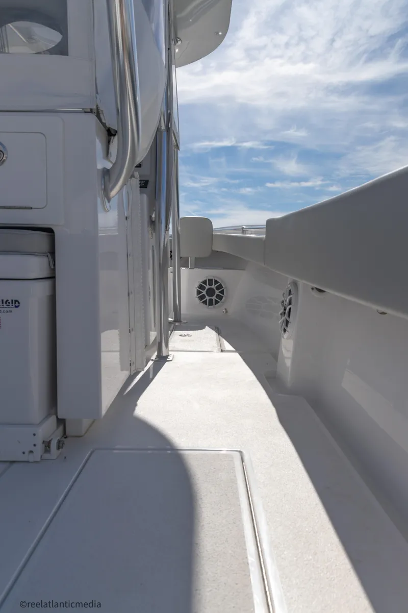 Slide: The Image of 2024 Onslow Bay 27XS boat deck with sleek design and modern features under a clear sky. - 14