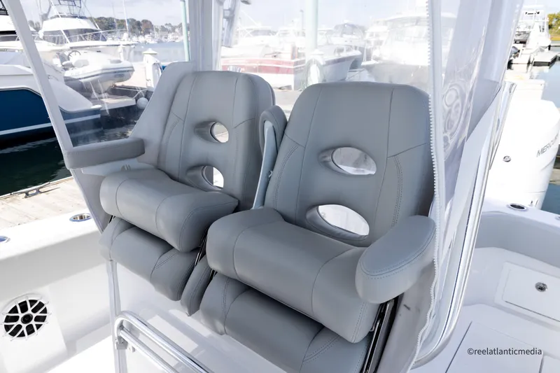 Slide: The Image of 2024 Onslow Bay 27XS boat with luxurious gray seating at a marina. - 16