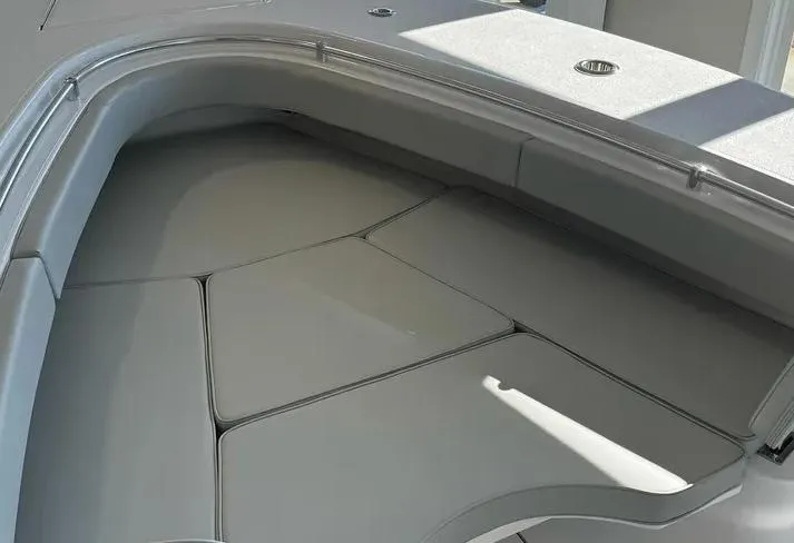 Slide: The Image of 2024 Onslow Bay 27XS boat interior with cushioned seating area. - 23