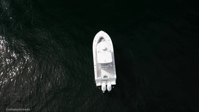 Slide: The Image of Aerial view of 2024 Onslow Bay 27XS boat on dark water. - 27