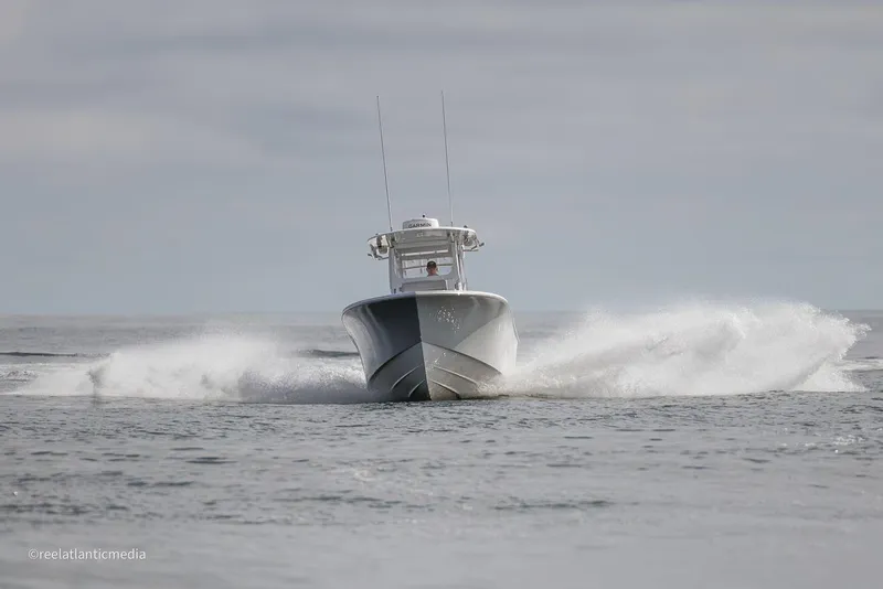 Slide: The Image of 2024 Onslow Bay 27XS boat speeding on open water. - 30