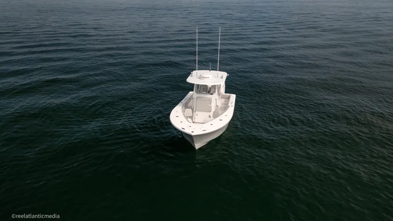 Slide: The Image of 2024 Onslow Bay 27XS boat on calm ocean waters. - 32