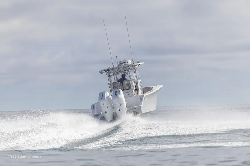 Slide: The Image of 2024 Onslow Bay 27XS boat speeding on open water. - 33