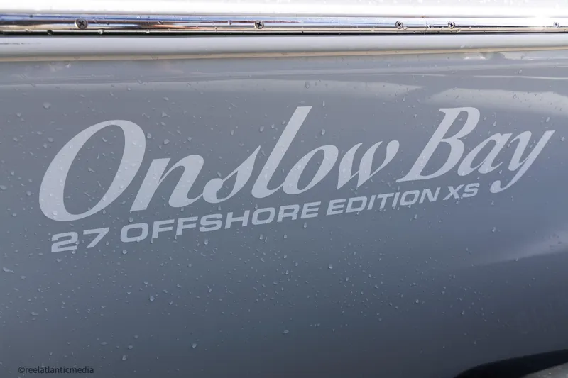 Slide: The Image of 2024 Onslow Bay 27XS Offshore Edition boat logo with water droplets. - 5