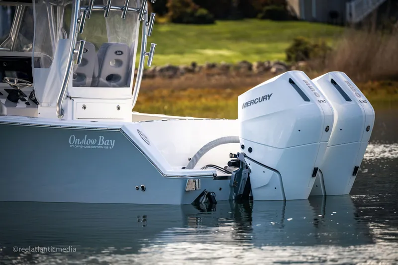 Slide: The Image of 2024 Onslow Bay 27XS boat with dual Mercury engines on calm water. - 6