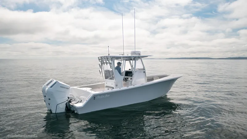 Slide: The Image of 2024 Onslow Bay 27XS boat on calm ocean waters under cloudy sky. - 9