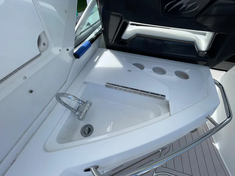 Slide: The Image of 2016 Monterey 335 Sport Yacht sink area with faucet and cup holders. - 10